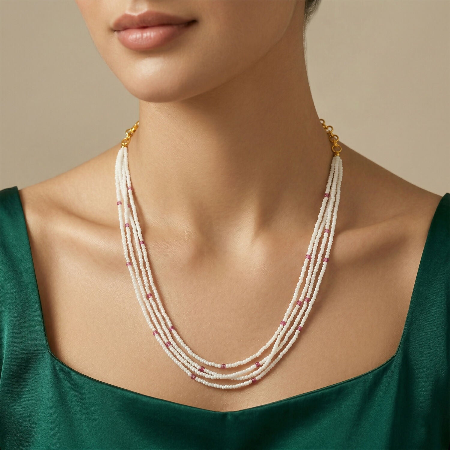 Layered mala necklace displayed on a neckline showing pink and pearl beads