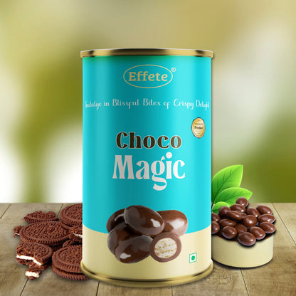 A blue and gold cylindrical container of chocolate balls, with cookies and a small bowl of candy at its base.