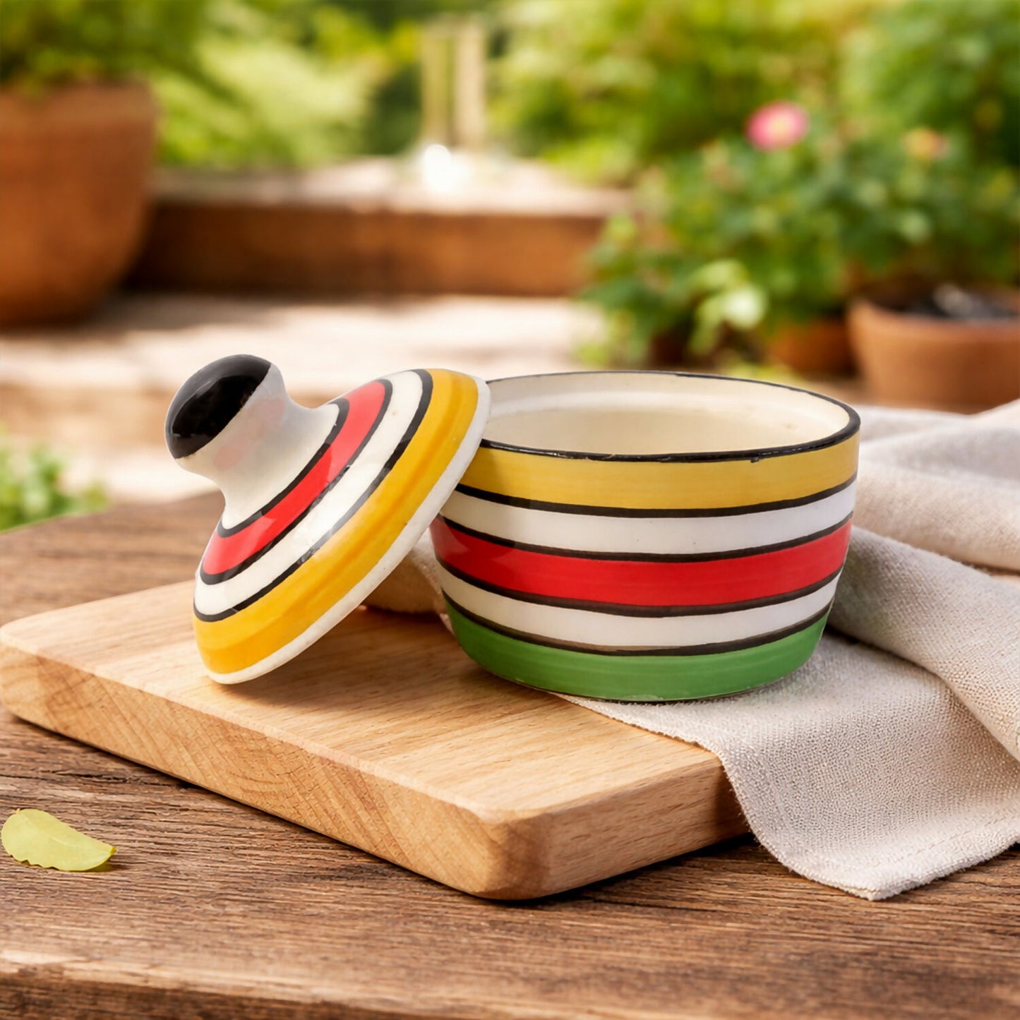 Hand holding the butter pot lid with convenient knob