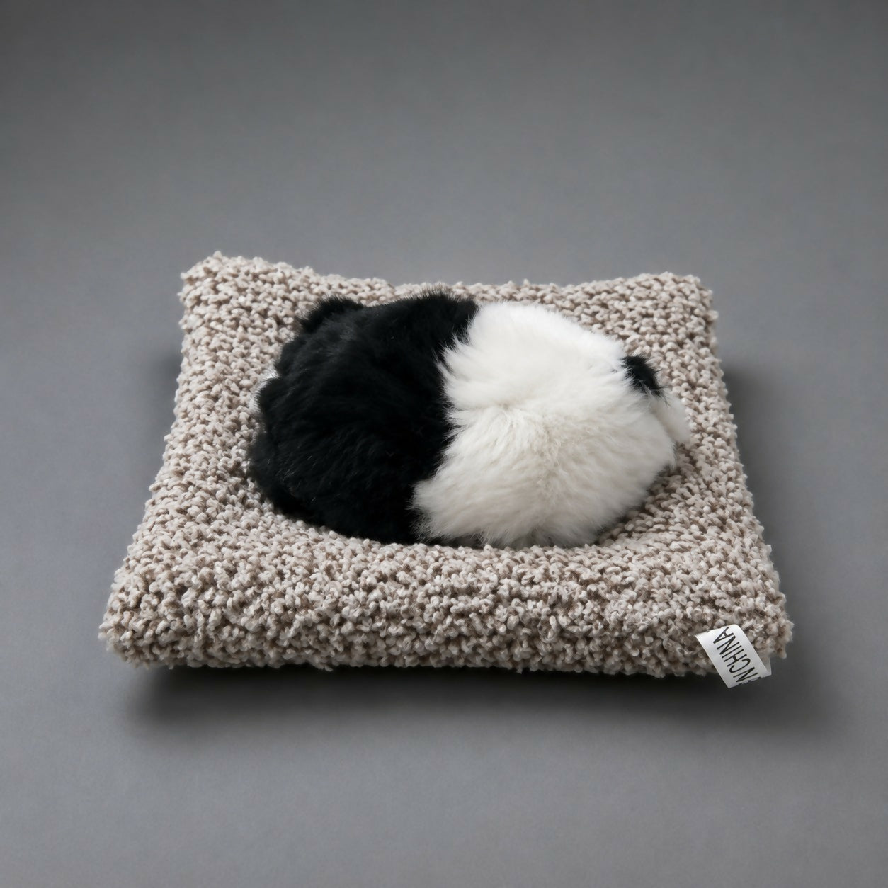 Sleeping cat plush toy showing cushion detail