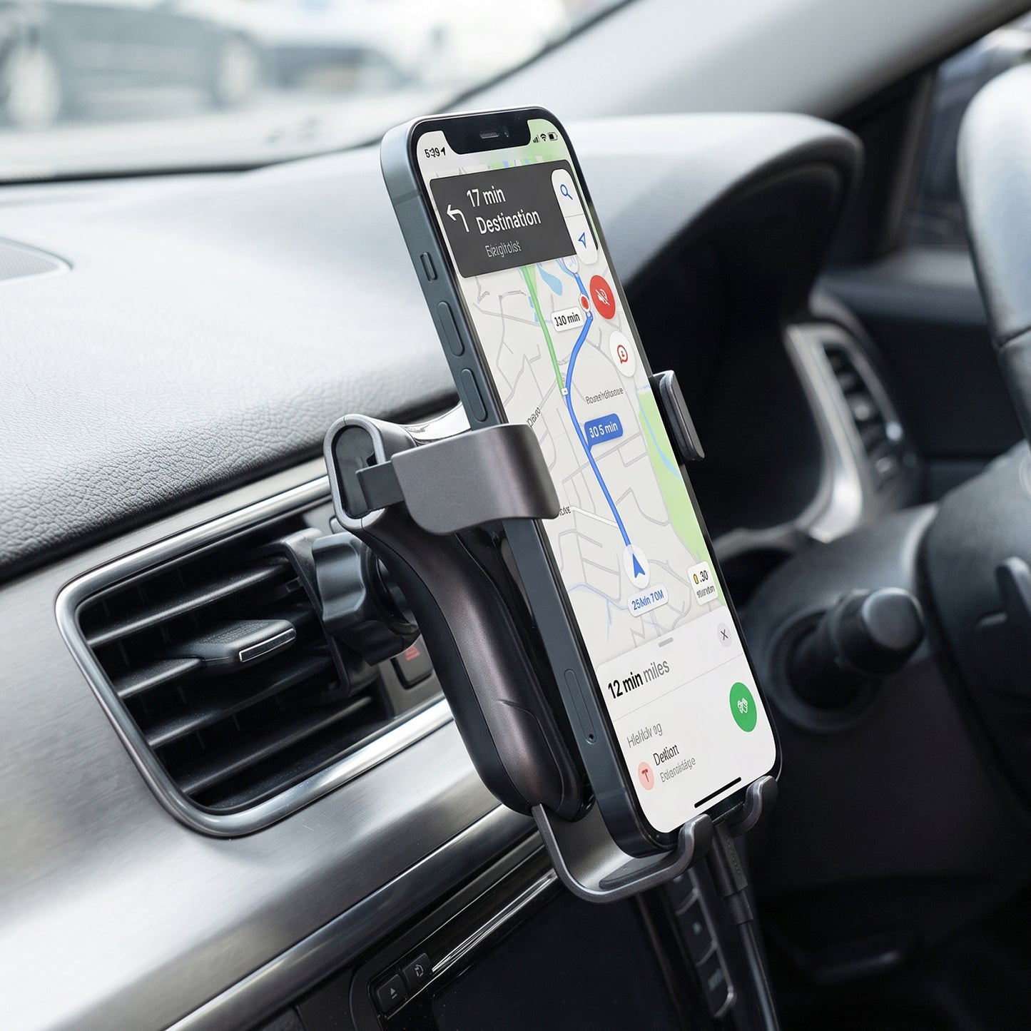 Car phone holder clipped to the air vent with a phone in place