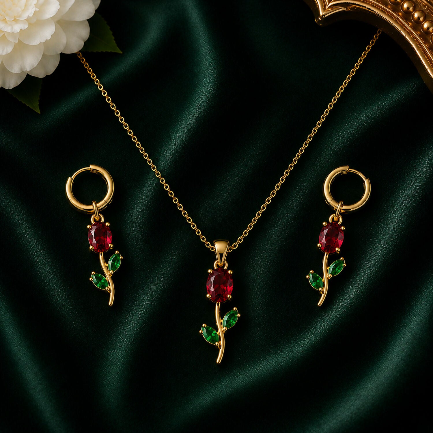 Ruby red crystal floral pendant necklace set with matching earrings displayed.