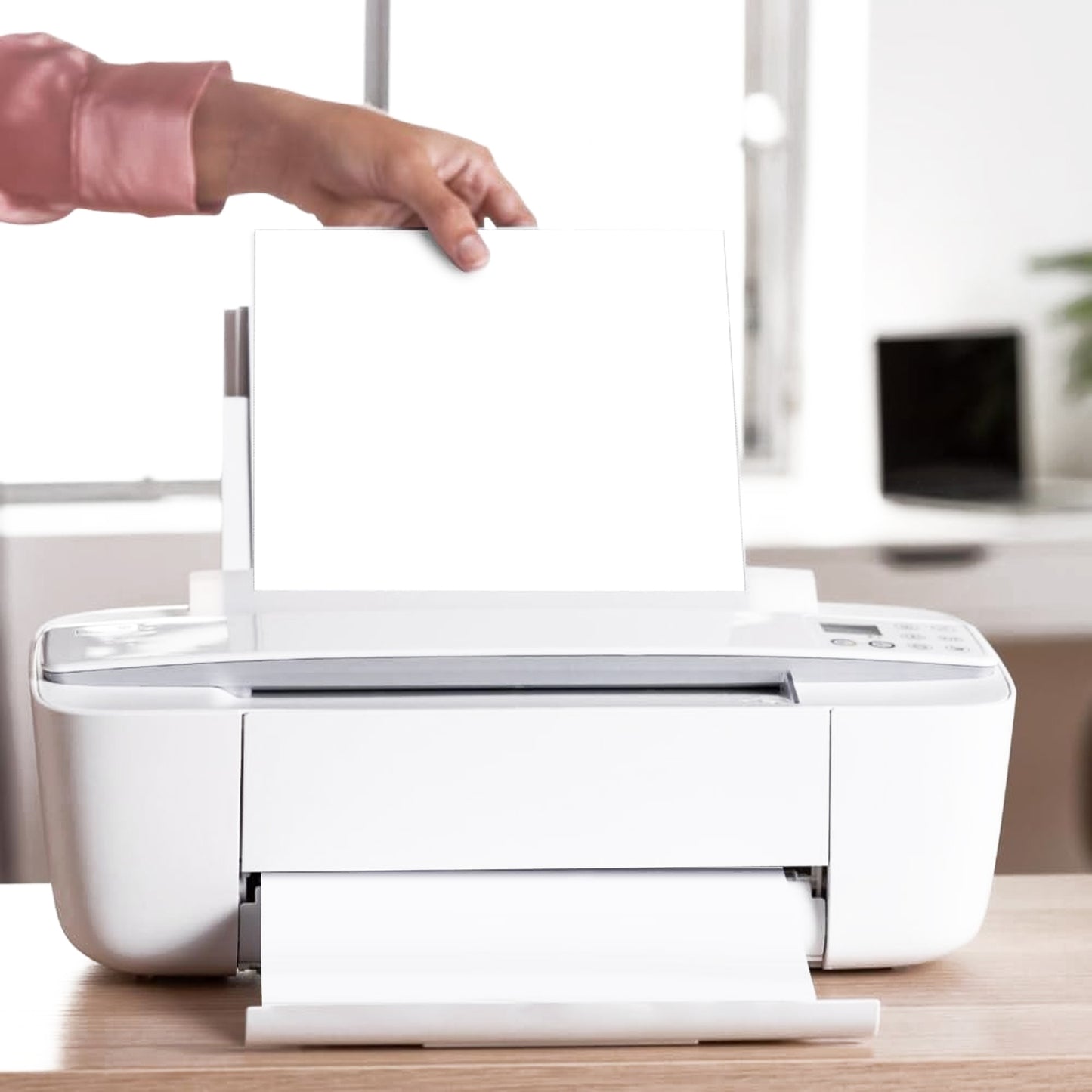 Stack of Papezo A4 paper next to a laser printer