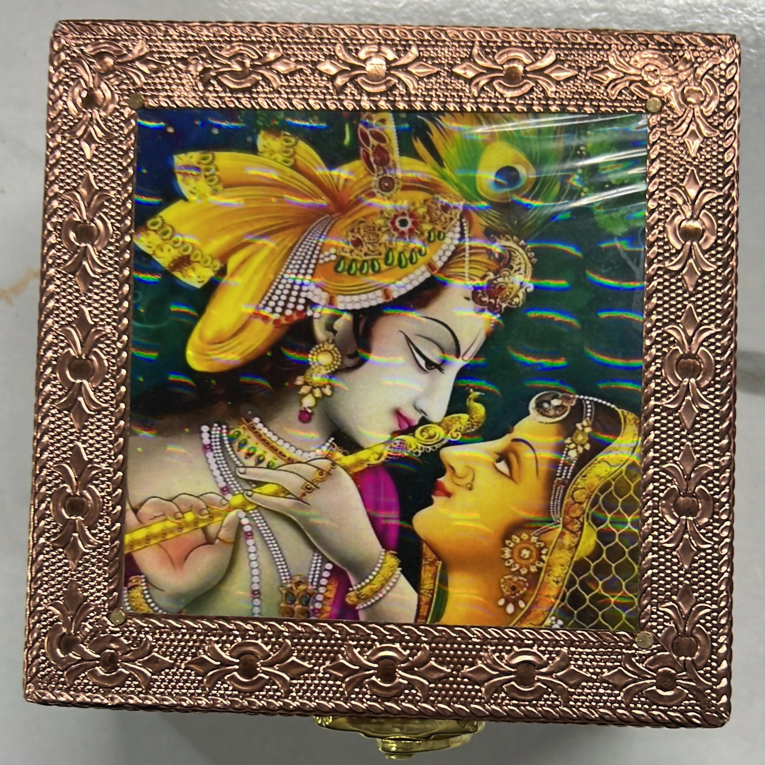 Side view of jewelry box with floral embossing and copper finish