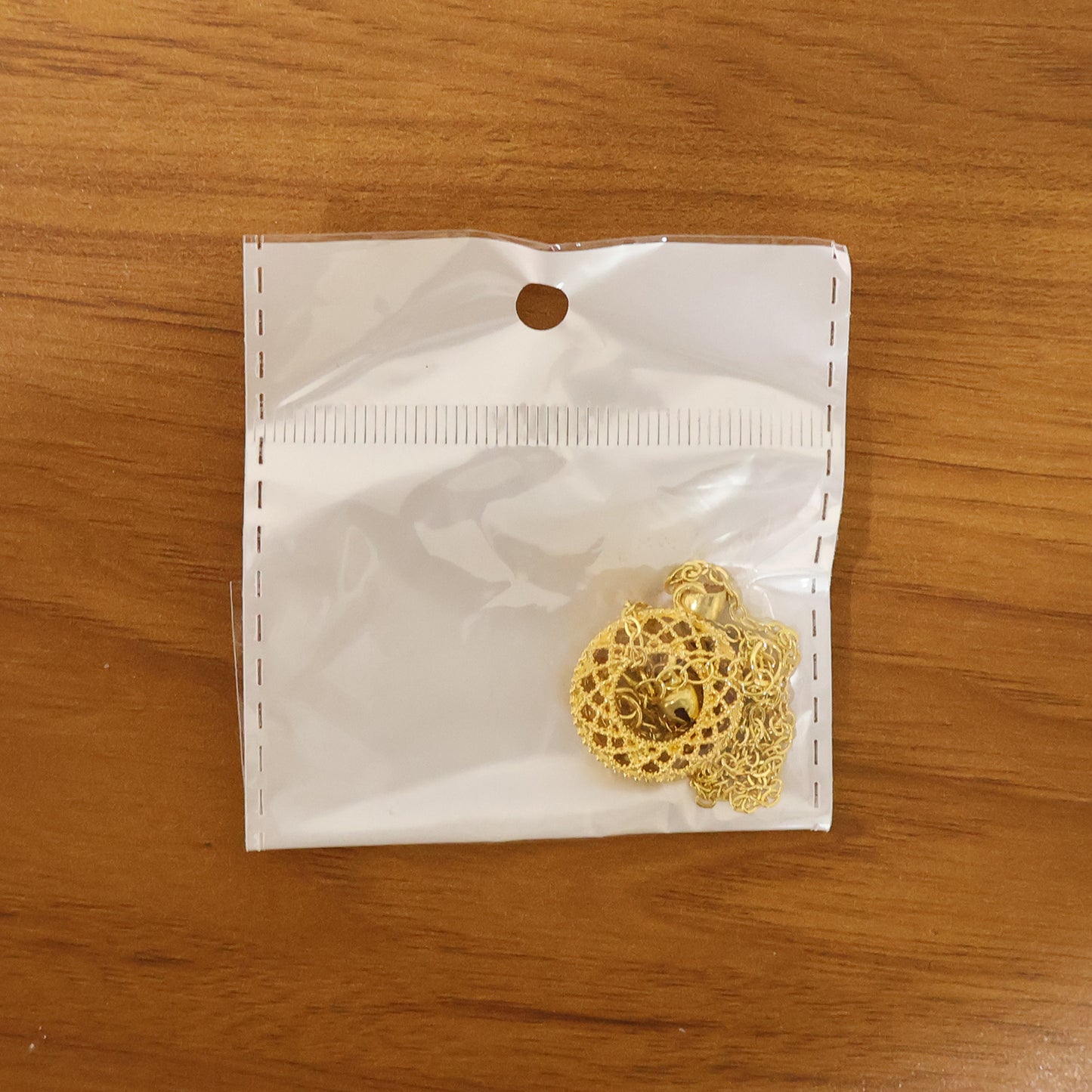 golden pendant with intricate patterns