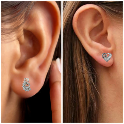 Close-up of silver heart studs featuring swirl design and sparkling CZ stones