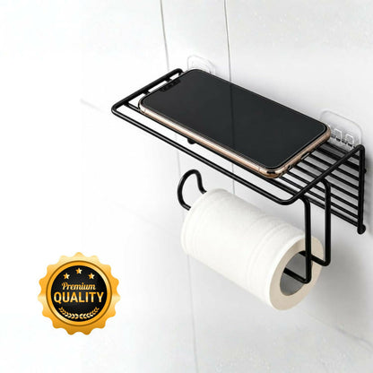 Black metal toilet paper holder with a phone resting on its top shelf, attached to a white tiled wall.