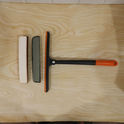 Complete view of glass cleaning squeegee in use on a window