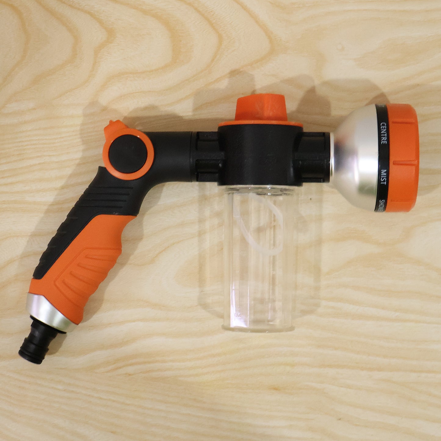 Complete set of adjustable hose spray nozzle with foam water gun in outdoor setting