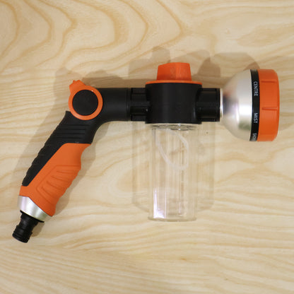 Complete set of adjustable hose spray nozzle with foam water gun in outdoor setting
