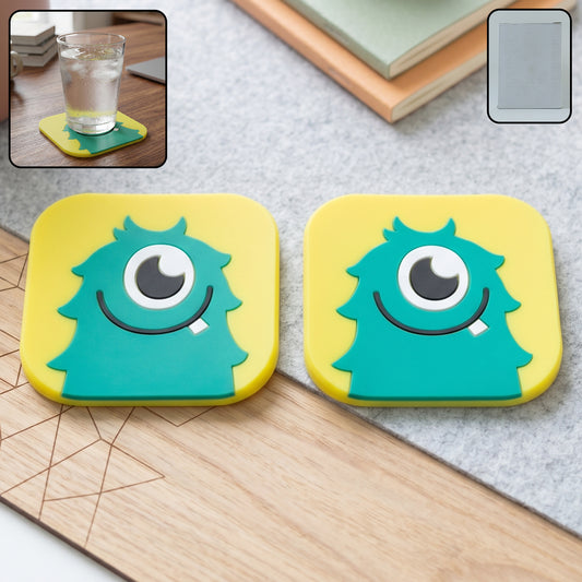 Cute cartoon monster silicone coaster set in yellow and teal colors for table protection.