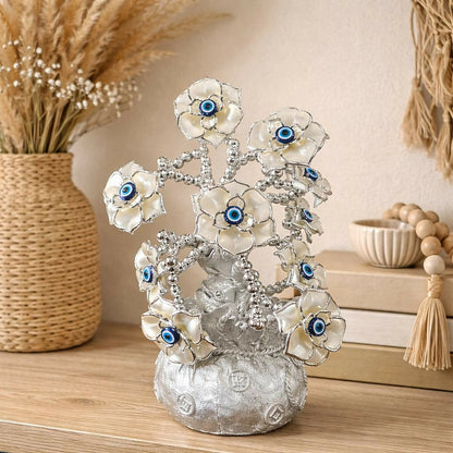 Silver lucky flower tree showpiece with blue evil eye accents on decorative silver branches