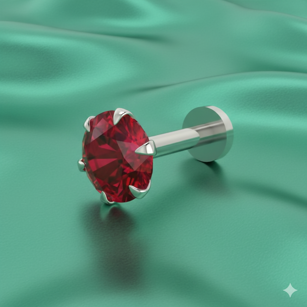 Close-up of red ruby nose stud with silver plating on white background