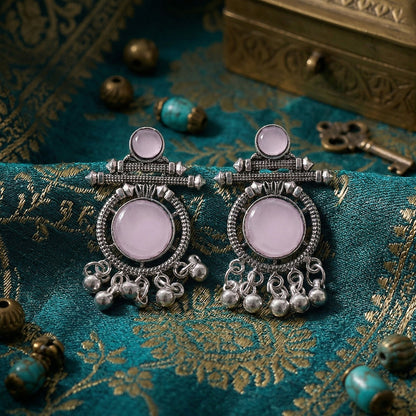 Close-up of intricate tribal metalwork on earrings