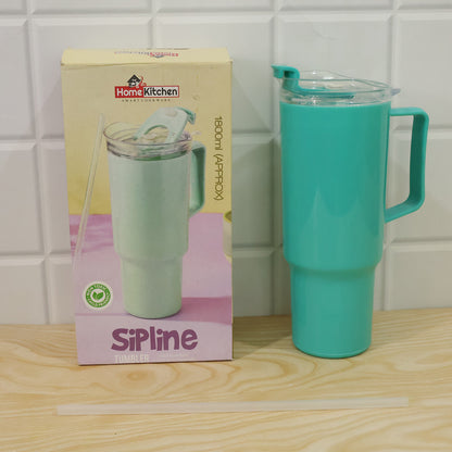 An aqua blue tumbler with a handle, clear lid, and straw stands next to its product box and a loose straw on a wooden