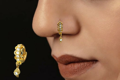 Close-up of gold plated CZ stone nosepin ring with delicate floral drop detailing