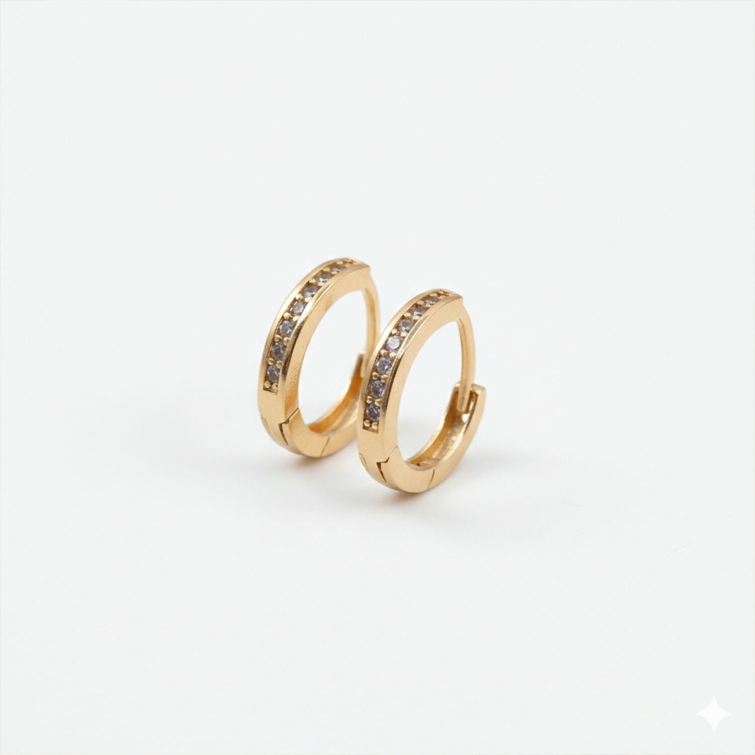 Pair of gold finish crystal studded hoop earrings highlighting subtle sparkle