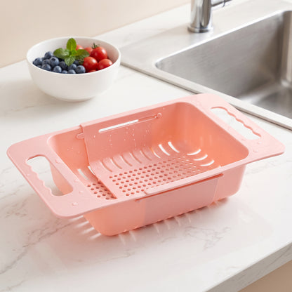 Colander resting over the sink draining washed vegetables
