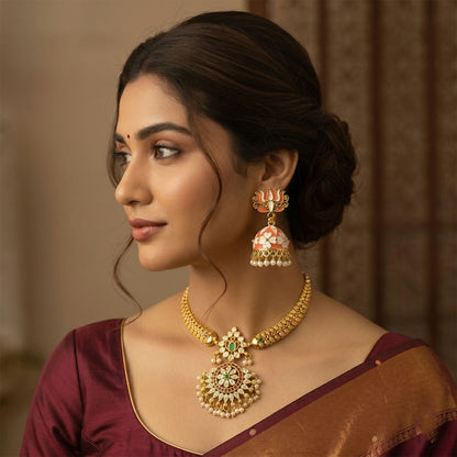 Close-up of peach enamel dome & golden outline on jhumka