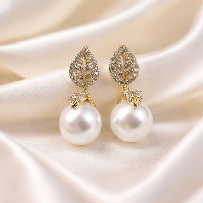 Close-up of gold leaf design on earrings
