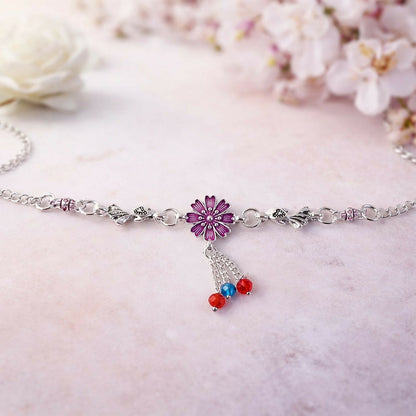Detail of silver flower charm bracelet with colorful dangling beads