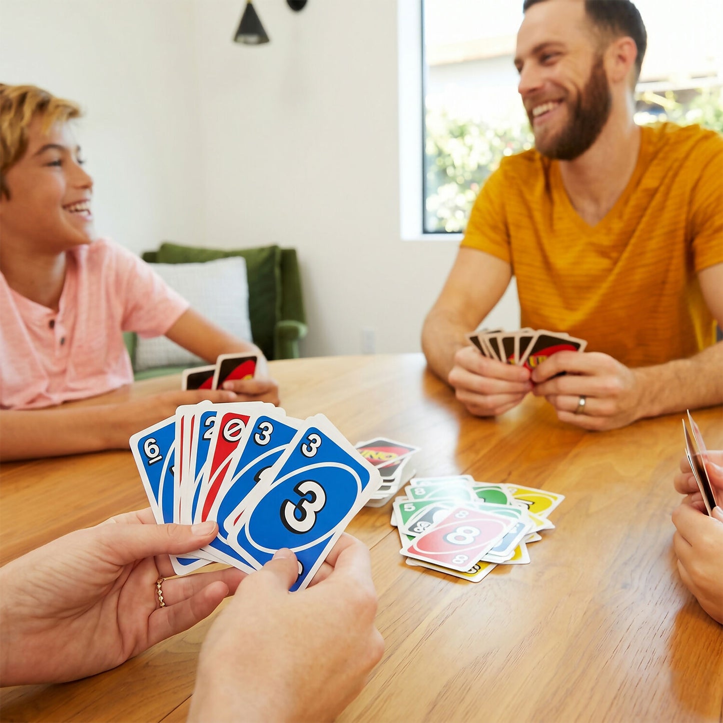 Players holding UNO customizable wild cards