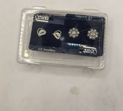 Silver heart and flower stud earrings displayed in jewelry case ready for gifting