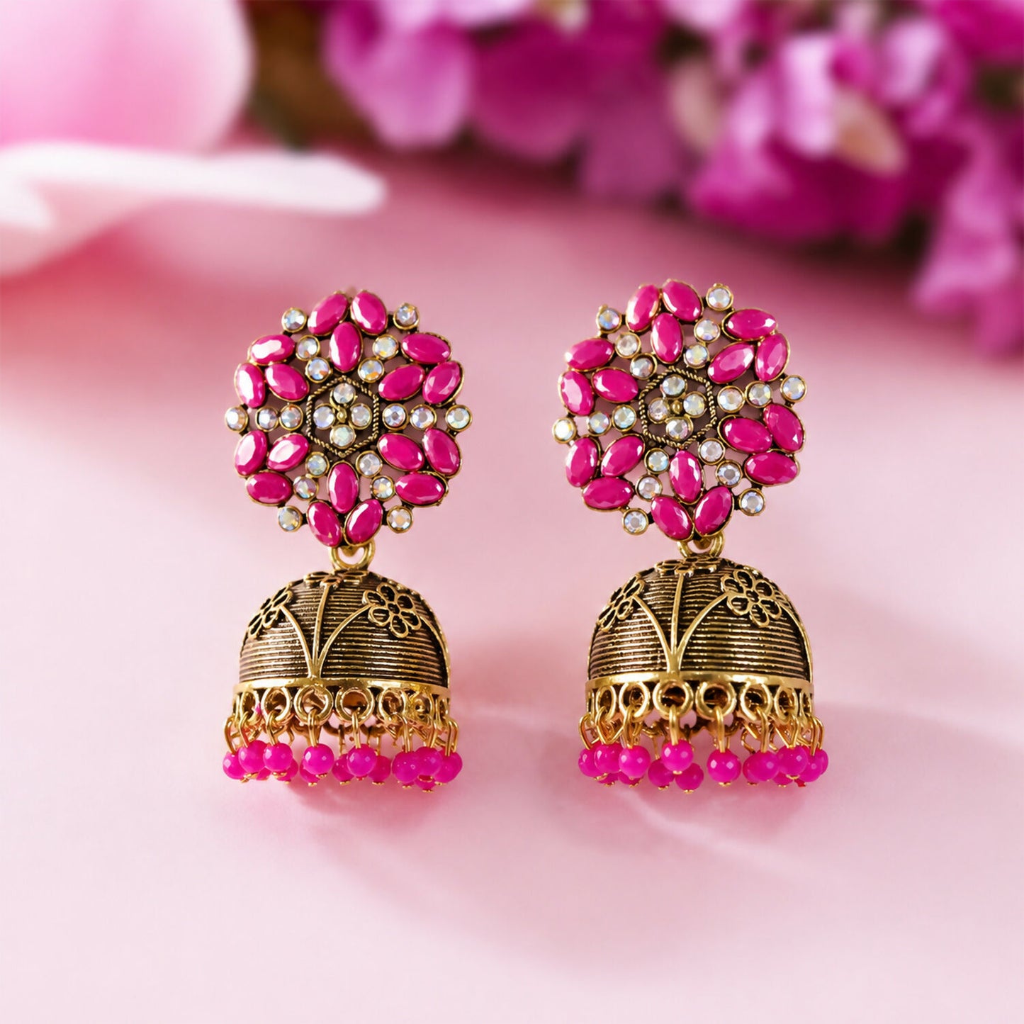 Antique gold jhumka earrings with pink beads and floral top, front view