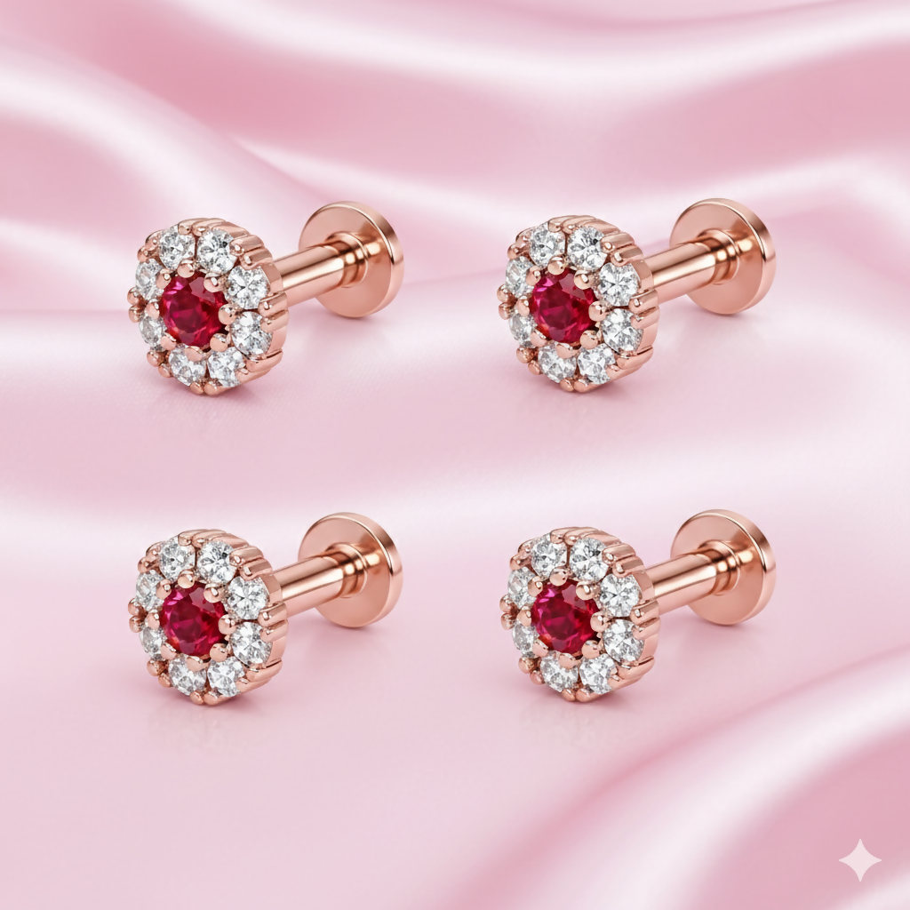 Single rose gold nose pin stud with ruby center and diamond halo on white background