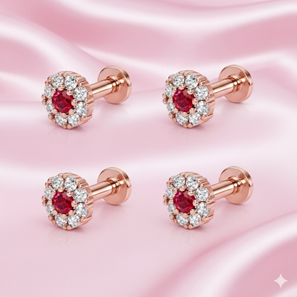 Single rose gold nose pin stud with ruby center and diamond halo on white background