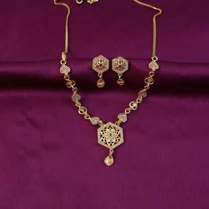Matching earrings with gold-tone finish and intricate design