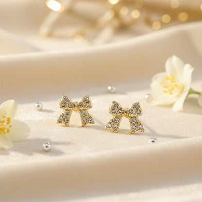 Close-up of gold plated rhinestone ribbon stud earring