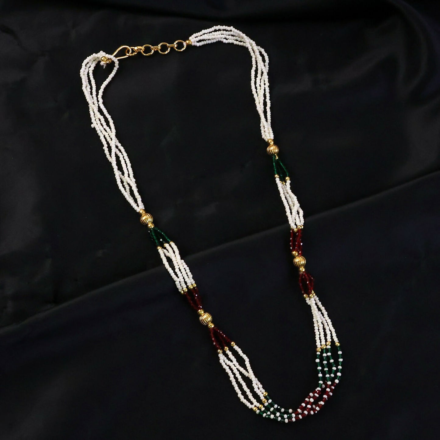 Layered pearl mala necklace showing red and green bead details