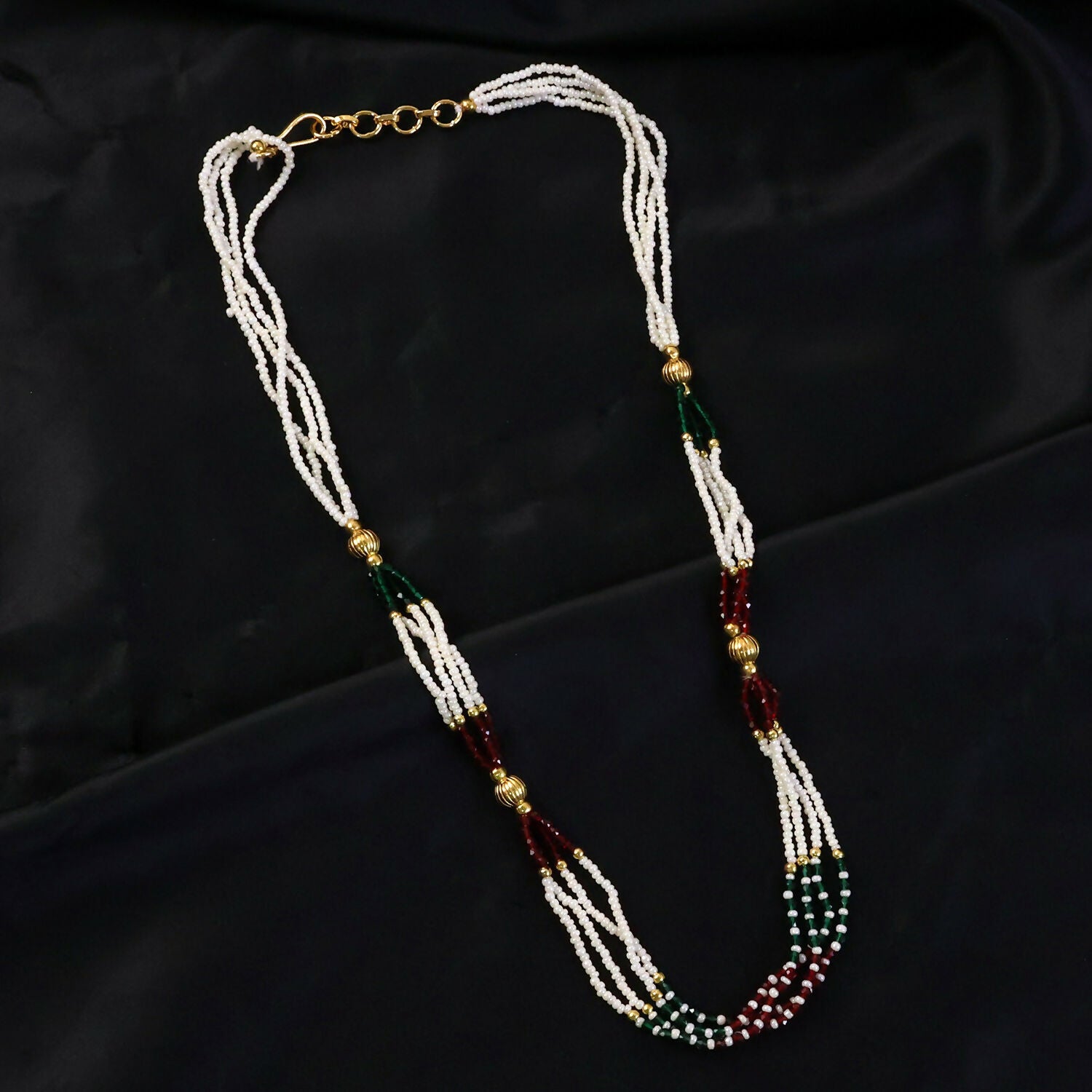Layered pearl mala necklace showing red and green bead details