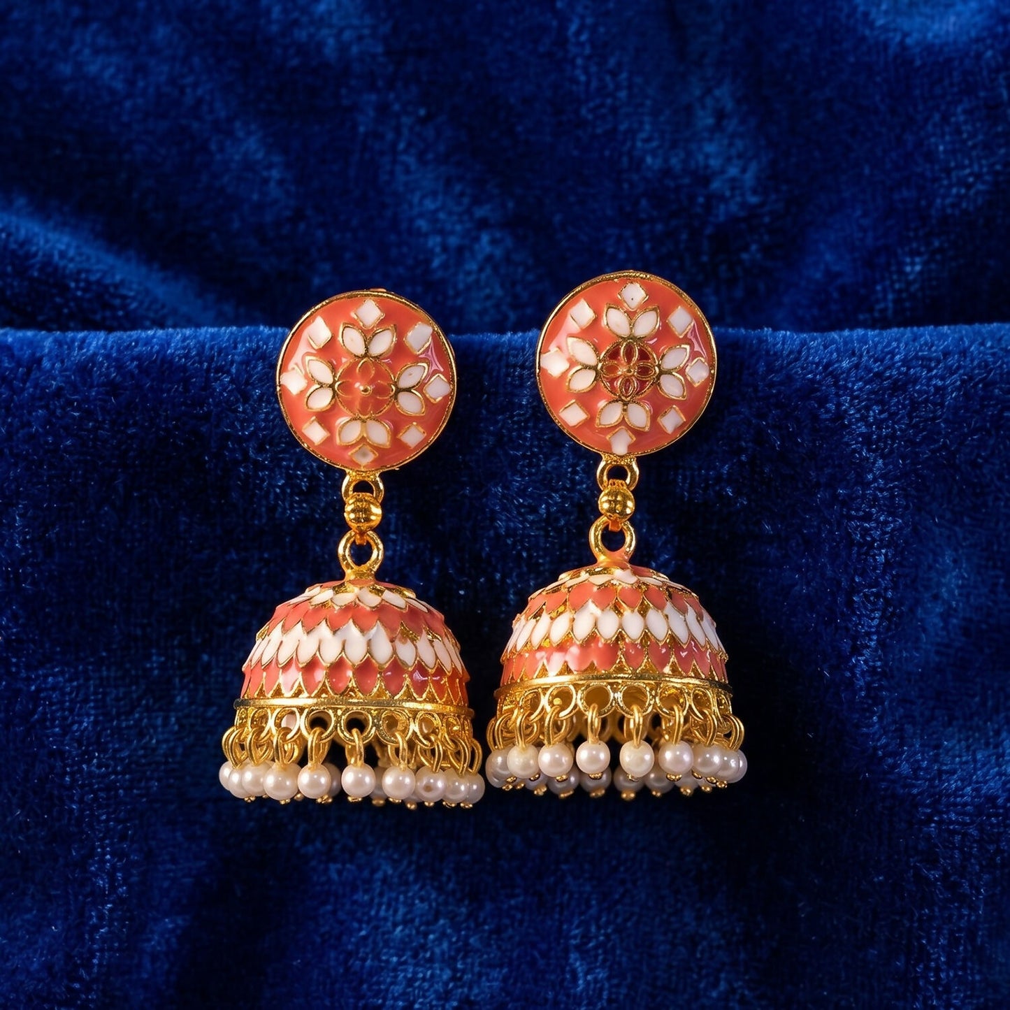 Golden finish and pearl drops detail on peach jhumka earrings