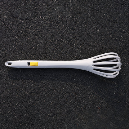 White manual egg beater with ergonomic handle for comfortable use.