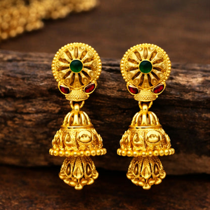 Close-up of elegant gold plated jhumka earrings showcasing intricate pyramid-shaped danglers
