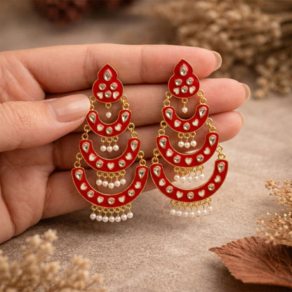 Red layered chandbali earrings styled with traditional Indian attire