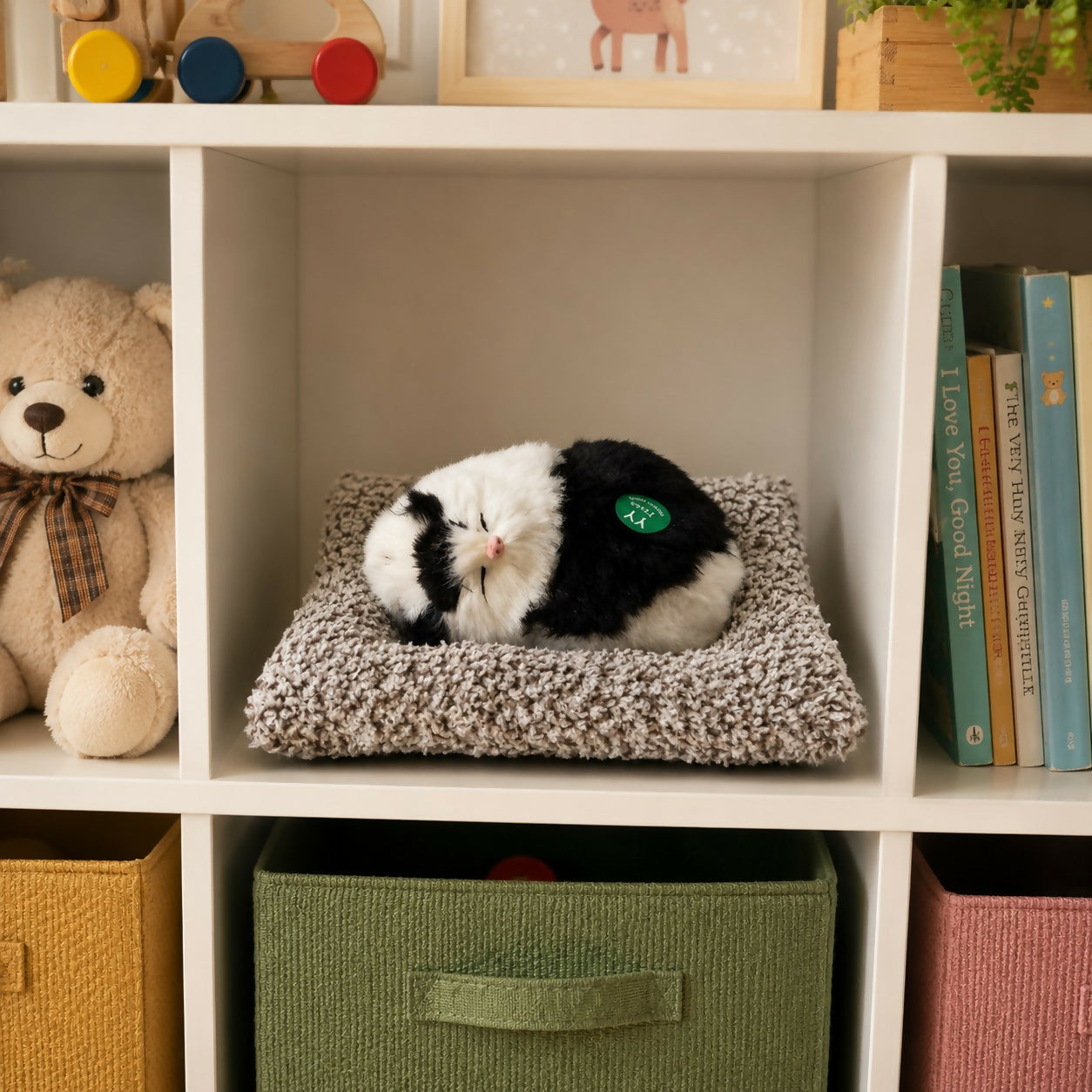 Top view of sleeping cat plush toy on cushion