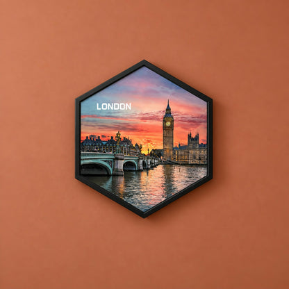 A black hexagon frame on an orange wall displays a vibrant sunset cityscape of London with Big Ben.
