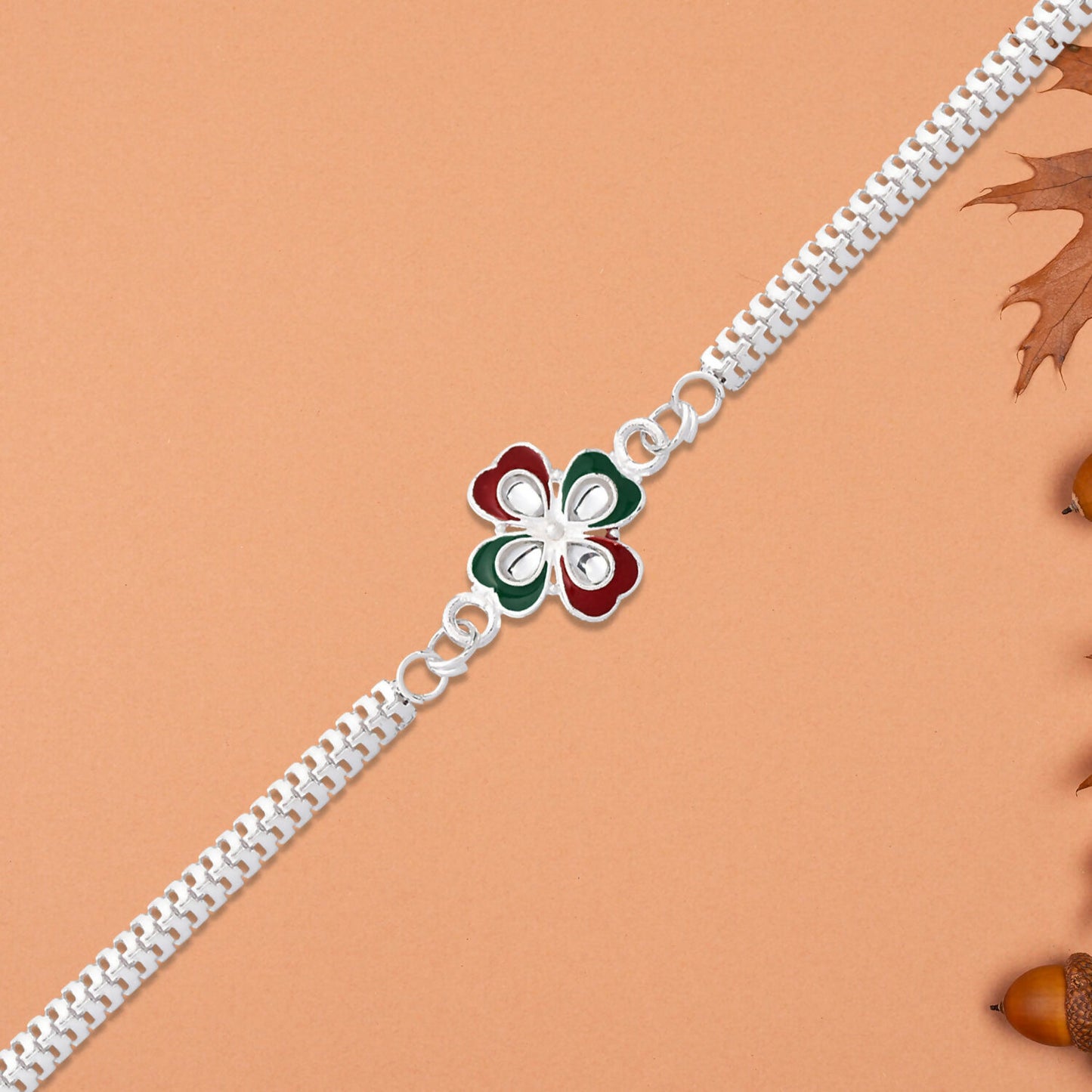 Vibrant tricolor enamel floral pattern detail on elegant Rakhi.