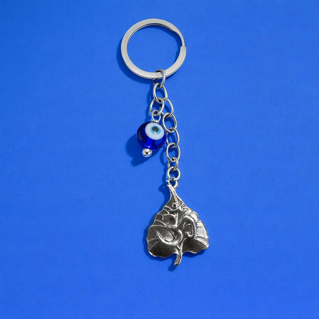 Front view of Om leaf evil eye keychain with blue bead