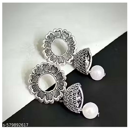 Multiple pairs of small oxidised jhumki earrings arranged together