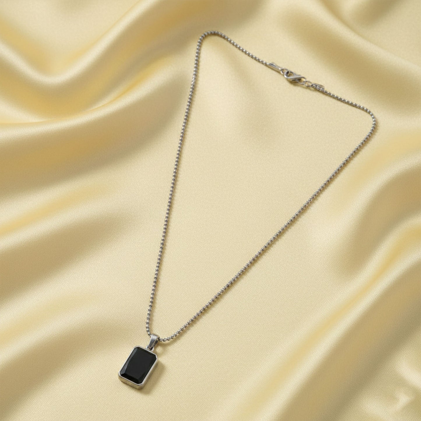 Side view of men's stainless-steel box chain pendant necklace