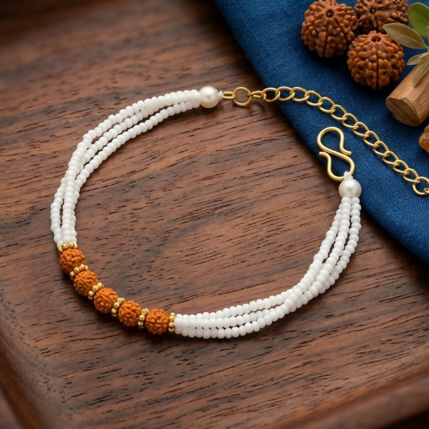 Natural rudraksha beads bracelet with white pearl strands and gold accents
