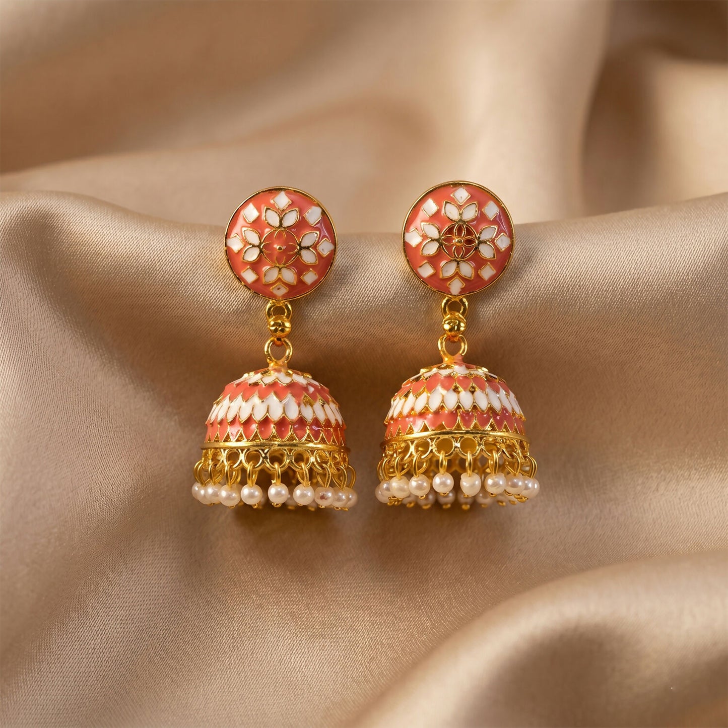 Peach round stud jhumka earrings on white background