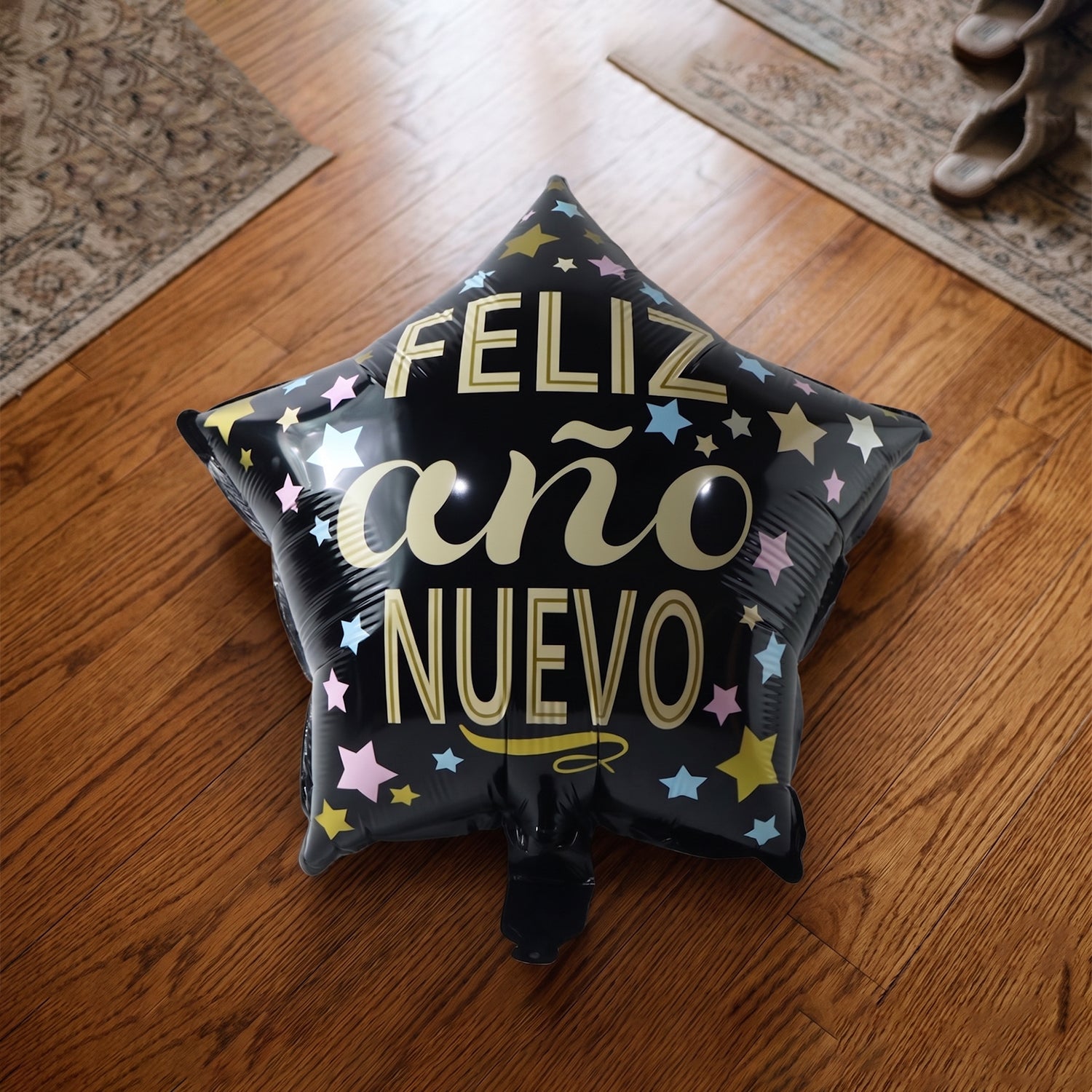 Black Star Feliz Ano Nuevo foil balloon displayed at party