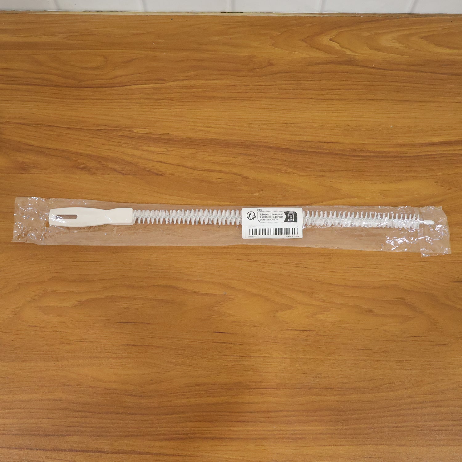 Flexible drain cleaning brush in kitchen setting