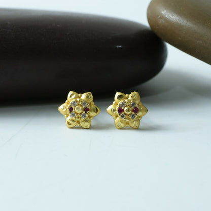 Gold stud earrings with floral design and sparkling stones in elegant finish