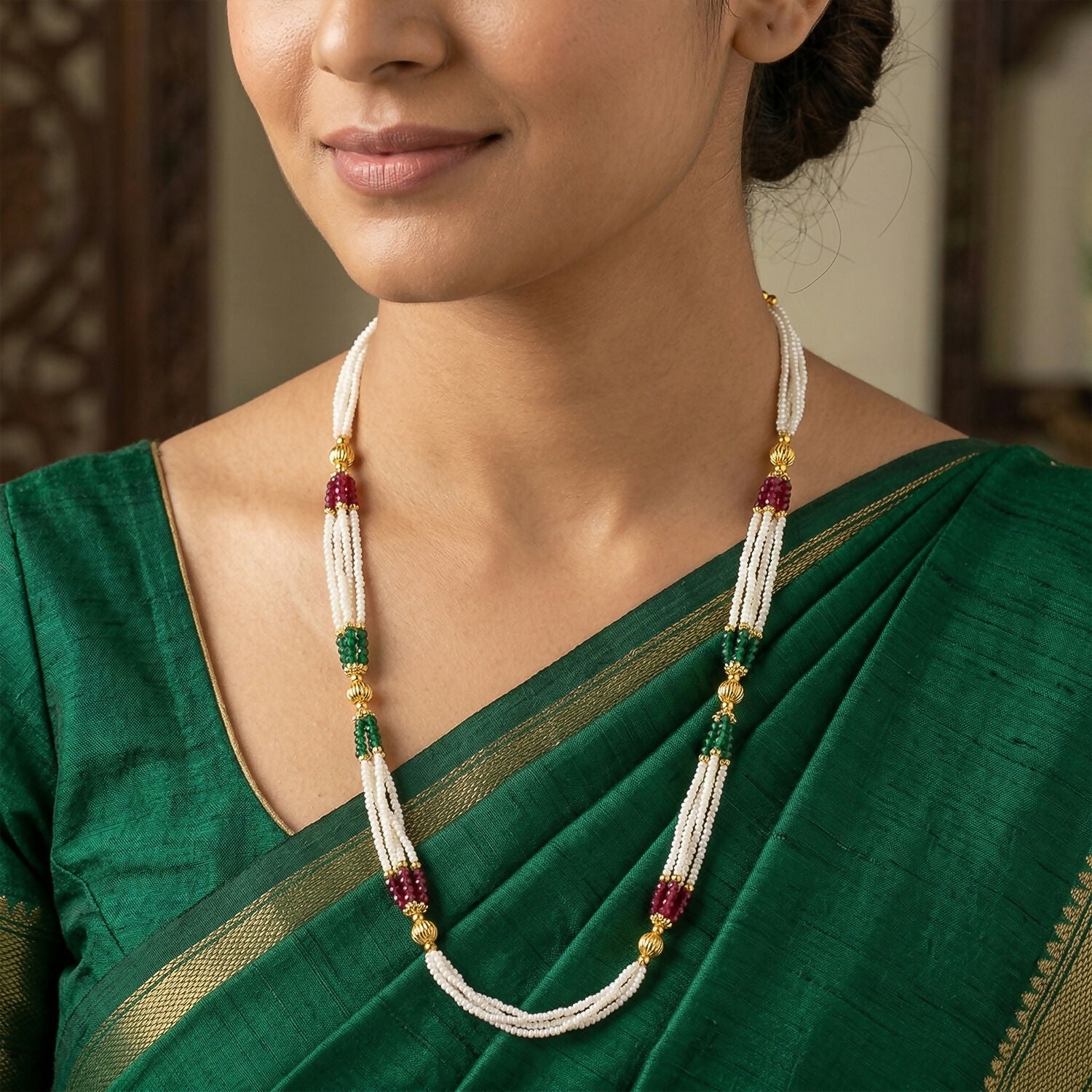 Close-up of white beads and gold accents on mala necklace